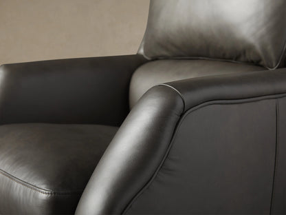 Alex Leather Desk Chair in dark Old West leather, high-back with cushion, 5-star wheeled base, front view on wood floor.