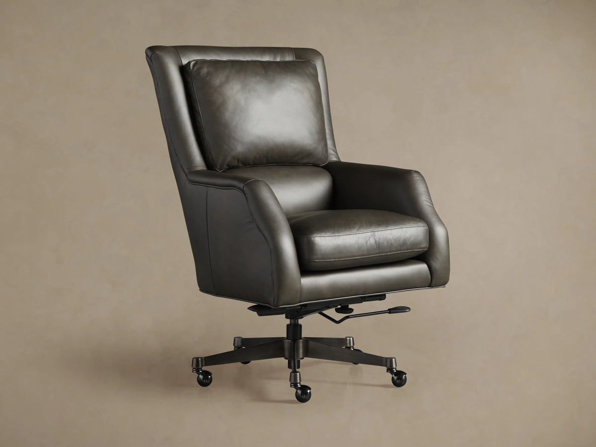 Dark gray Alex Leather Desk Chair, seen from the back-right, with a high back, detailed stitching, and a 5-star wheeled base.