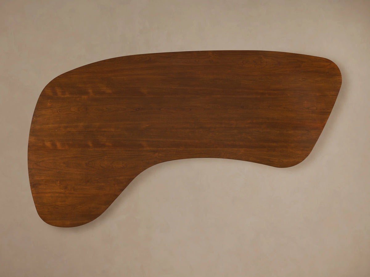Curved cherry wood Berkley Executive Desk top with a rich wood grain finish, displayed against a neutral background.