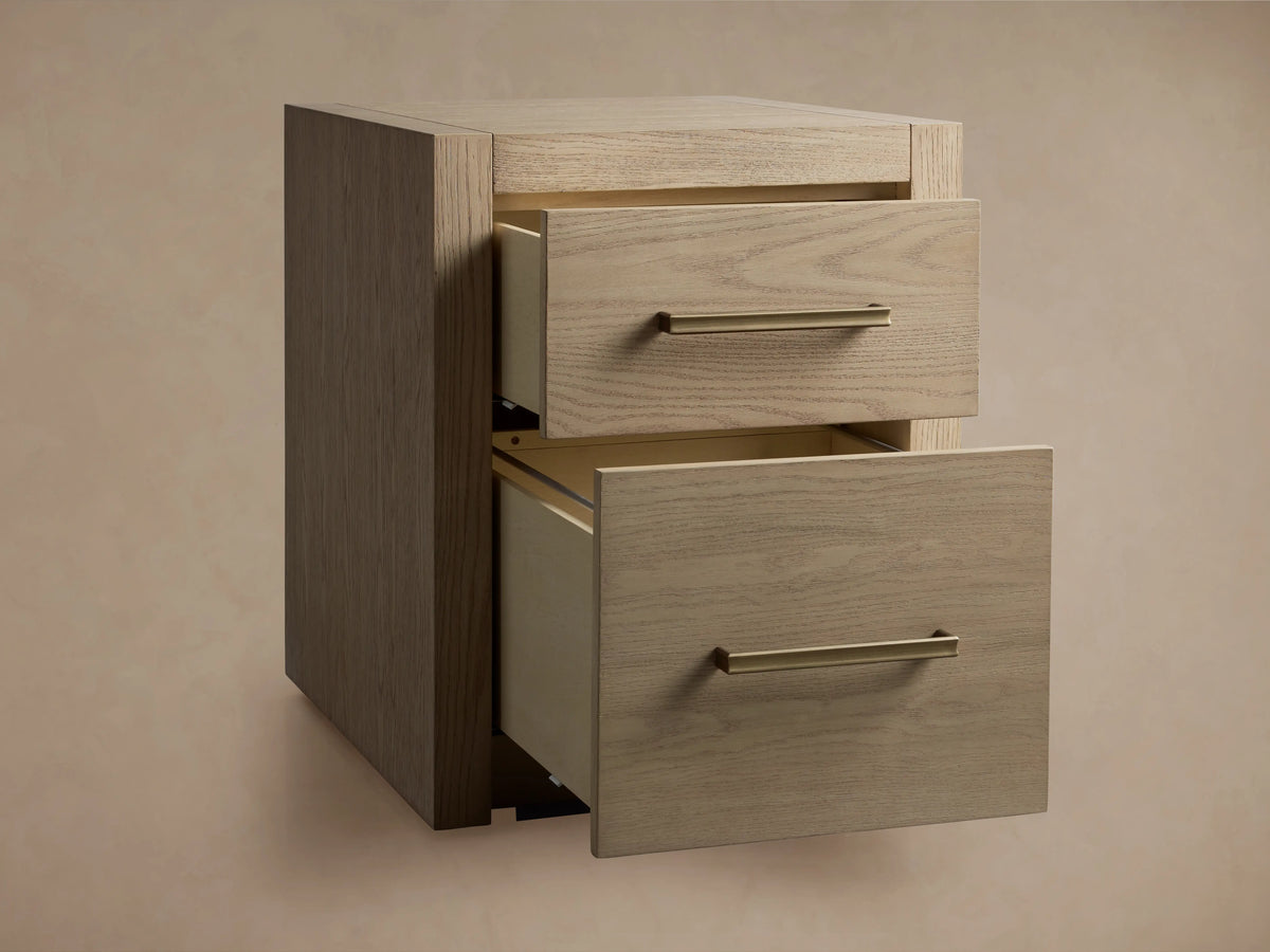 Bodhi Modular File in white oak with two drawers and brass pulls, displaying textured, organically aged wood finish on a wooden floor.