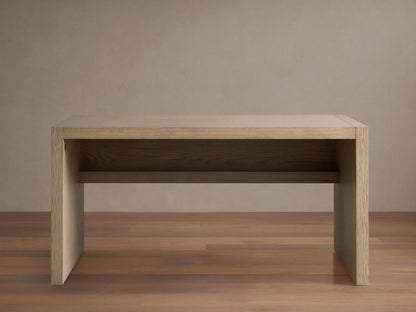 Bodhi Modular Desk made of solid white oak with wire-brushed finish, in a minimalist design, on a wood floor against a beige wall.