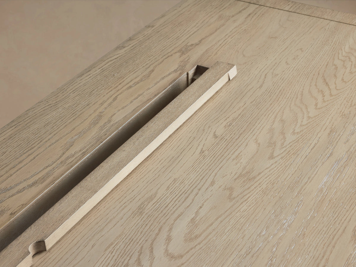 Bodhi Modular Desk in solid white oak features a wire-brushed surface with natural tones. Shows cord management slot.