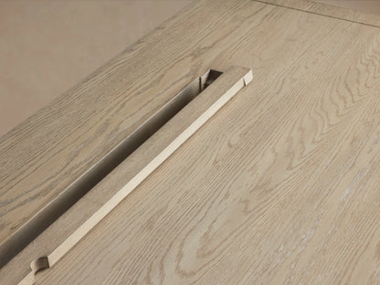 Bodhi Modular Desk in solid white oak features a wire-brushed surface with natural tones. Shows cord management slot.