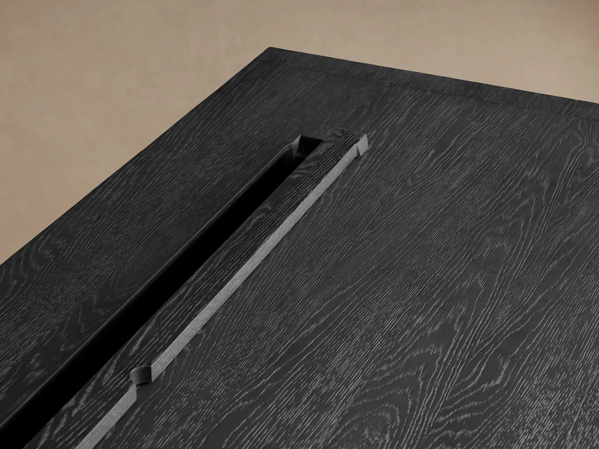 Front view of a dark wire-brushed Bodhi Executive Desk with 4 drawers & long brass pulls. One drawer is open.