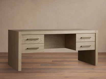 Bodhi Executive Desk, light wire-brushed white oak with an aged look, 4 drawers & horizontal brass pulls, front view.