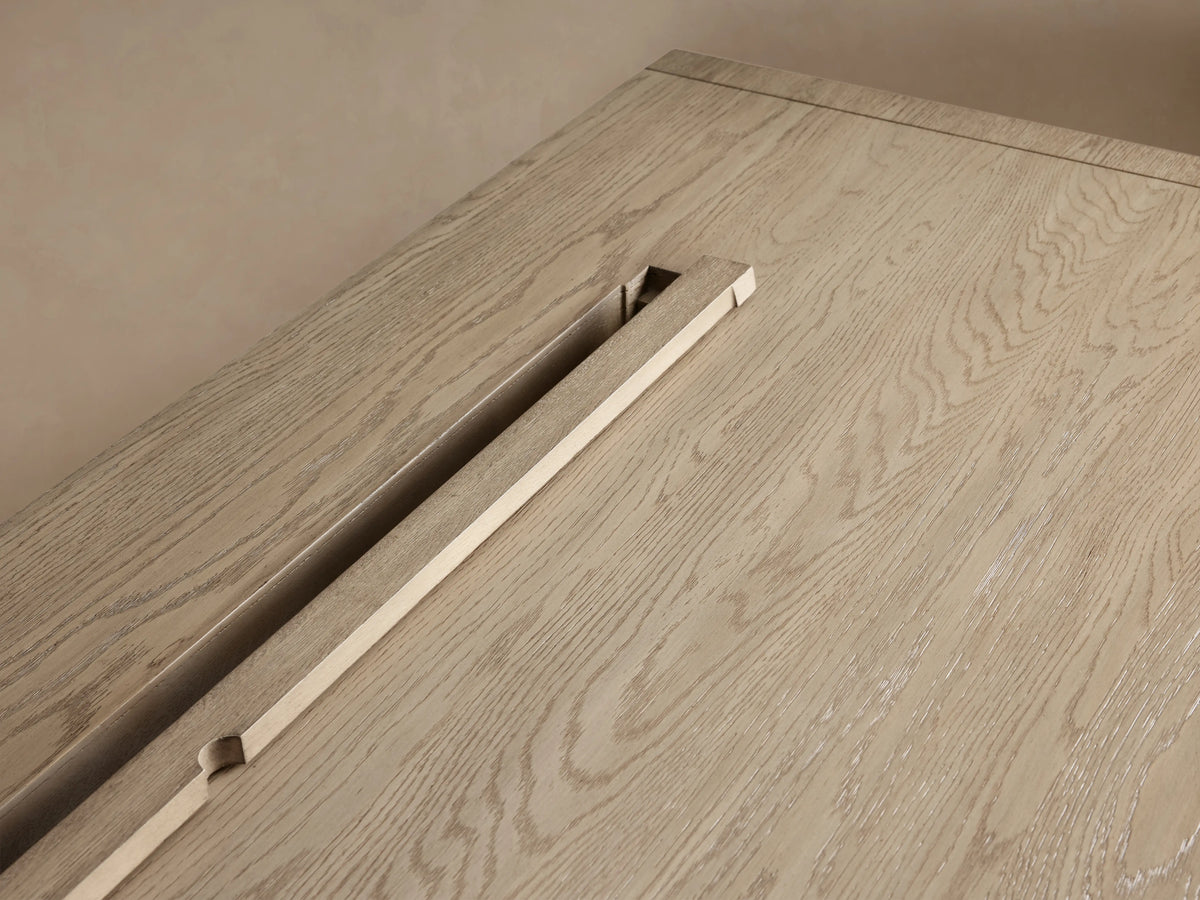 Bodhi Executive Desk. Light wire-brushed white oak desk, straight-on. Four drawers, two each side, with brass pulls.