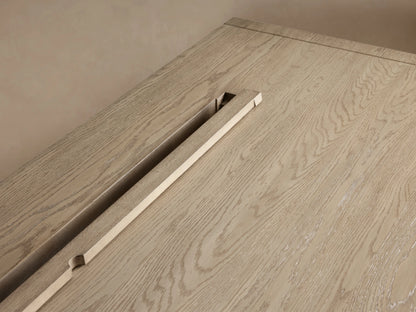 Bodhi Executive Desk. Light wire-brushed white oak desk, straight-on. Four drawers, two each side, with brass pulls.
