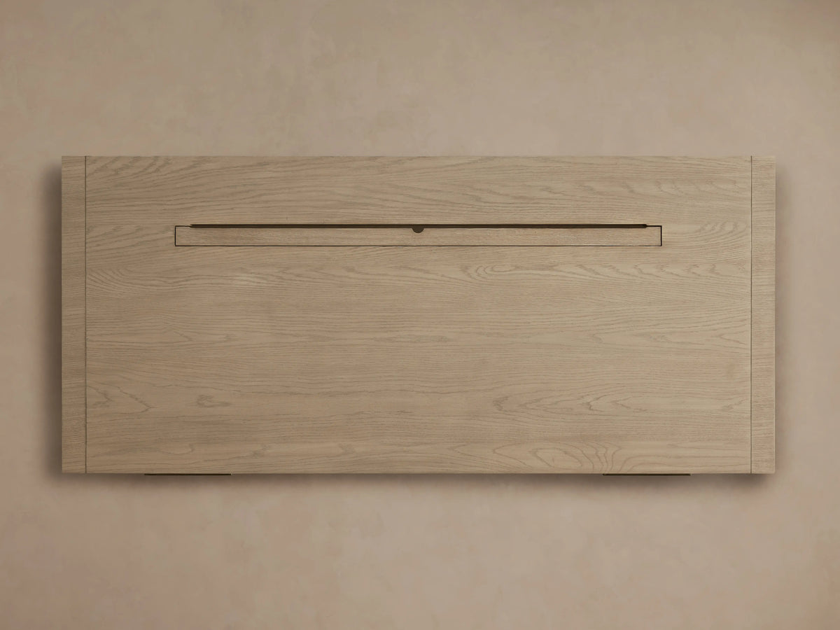 Front view of Bodhi Executive Desk crafted from light, wire-brushed white oak, with a wide, open central storage cubby.