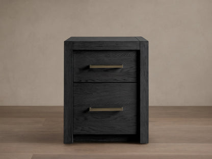 Bodhi Modular File in black oak, featuring two drawers with brass pulls on a wood floor. The design is simple and modern.