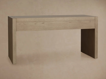 Bodhi Writing Desk, made from light wire-brushed white oak, featuring a wide integrated drawer and two solid panel legs.