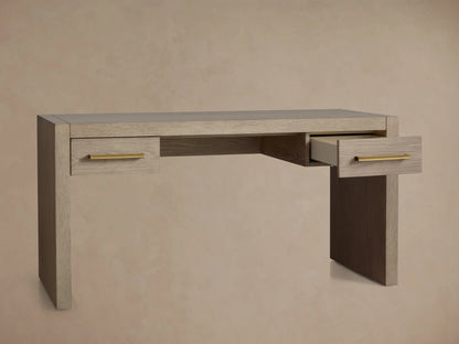 Light wire-brushed oak Bodhi Writing Desk with two drawers & brass pulls. One drawer is partially open, facing right.