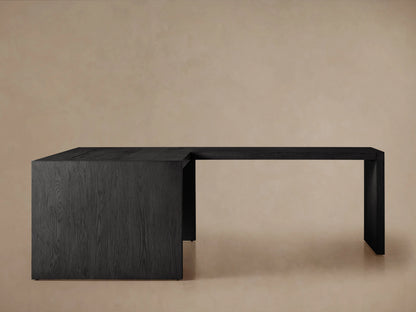 L-shaped Bodhi Modular Desk with Return Desk, black wire-brushed oak veneer, seen from front on light background.