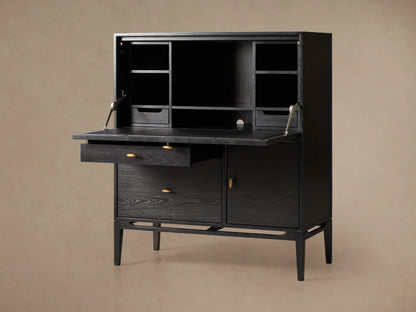 Brock Hideaway Desk made of dark ash wood with open top shelves, closed cabinet, leather writing surface, and slim wooden legs.