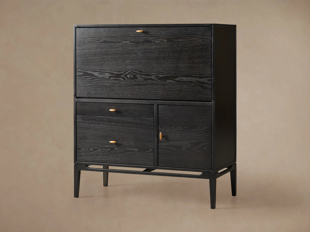 Brock Hideaway Desk in dark ash wood finish with clear lacquer, featuring gold knob accents and standing on four legs.