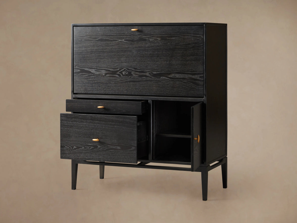 Brock Hideaway Desk made of dark ash wood with open drawers and a door, showing internal shelves on a beige background.