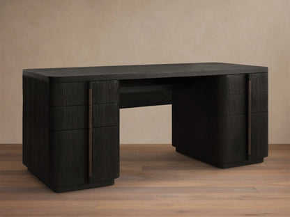 Front view of a dark wood finish writing desk with rounded corners and six drawers featuring long, vertical bronze-toned pulls.