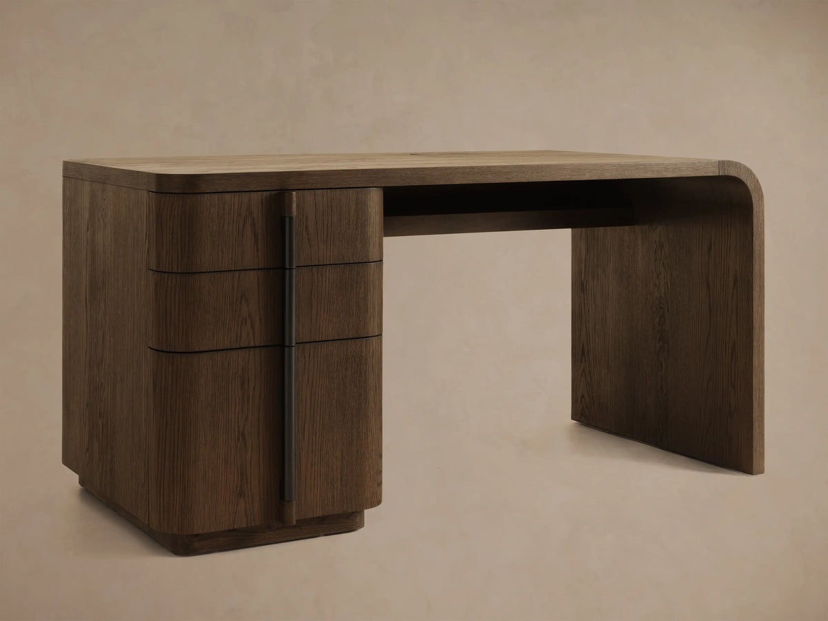 Front view of a dark brown wooden desk with three curved drawers on the left and a continuous tabletop and right leg.