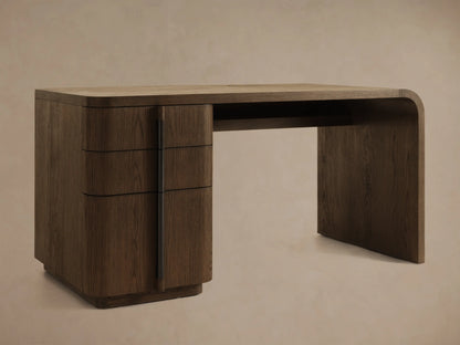 Front view of a dark brown wooden desk with three curved drawers on the left and a continuous tabletop and right leg.
