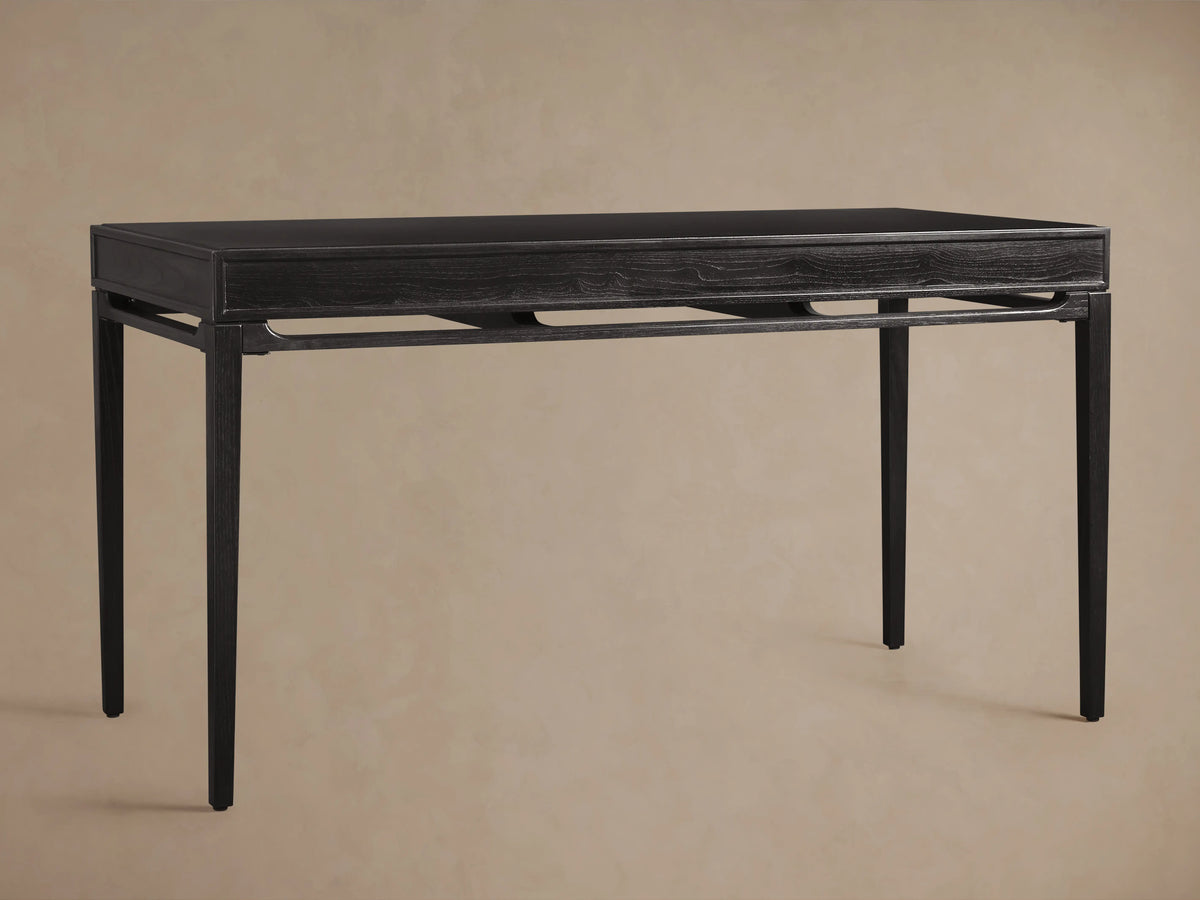 Brock Writing Desk made of dark ash wood with clean lines, featuring a flat leather writing surface and sleek tapered legs.