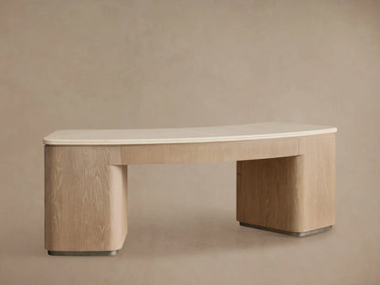 Close-up of Caden Executive Desk in Sand oak. Cream marble top with rounded edges. Bottom drawer partially open, brushed nickel pull.