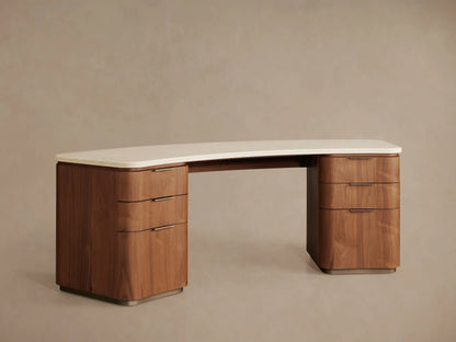 Caden Executive Desk: Curved cream stone top, dark walnut wood base with rounded edges, 6 drawers & thin black pulls.