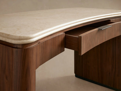 Caden Writing Desk in dark walnut wood with curved legs and a cream marble top, featuring a central drawer with a pull.