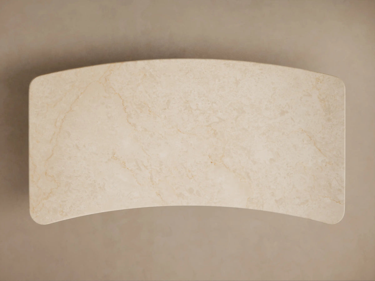 Caden Writing Desk: dark walnut wood with a cream marble top, rounded edges, and curved side panels, front view.