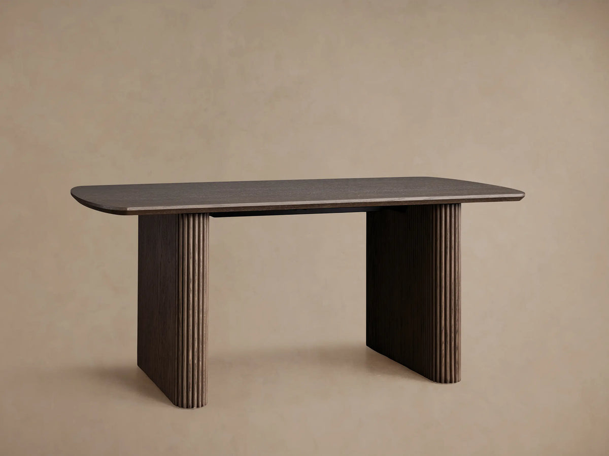 Front view of the dark brown red oak Camonte Lift Desk, featuring fluted legs and a control panel on the right side.