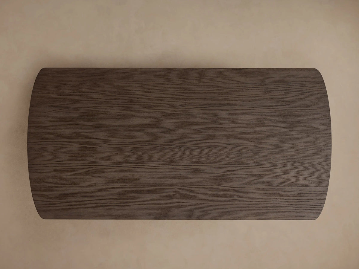 Front view of the dark brown Camonte Lift Desk, featuring a rectangular top with rounded corners and two ribbed pedestal legs.