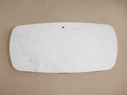 Top-down view of the white Carrara marble desktop with grey veining and a circular cord management opening on the Danny Executive Desk.