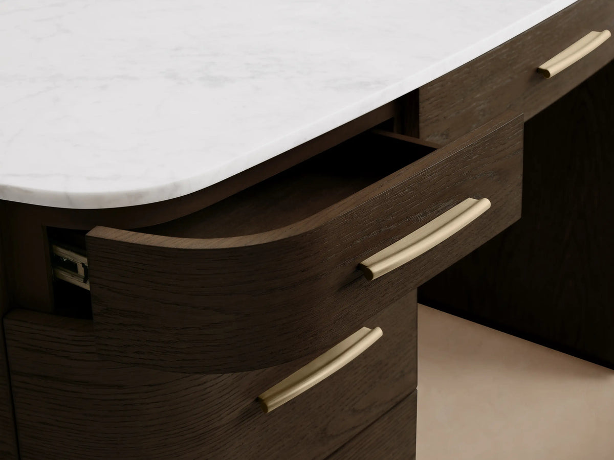 Close-up of the Danny Executive Desk, showing the white Carrara marble top and an open dark oak veneer drawer with gold pull.