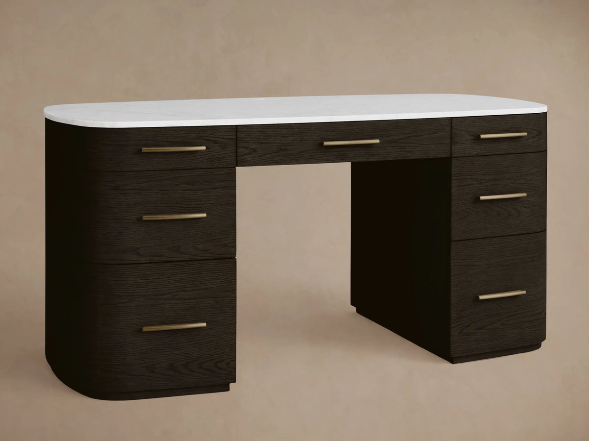 Danny Executive Desk: Dark ebony wood with a white Carrara marble top, 7 drawers, and brass-finished handles. Front view.
