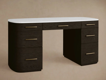 Danny Executive Desk: Dark ebony wood with a white Carrara marble top, 7 drawers, and brass-finished handles. Front view.