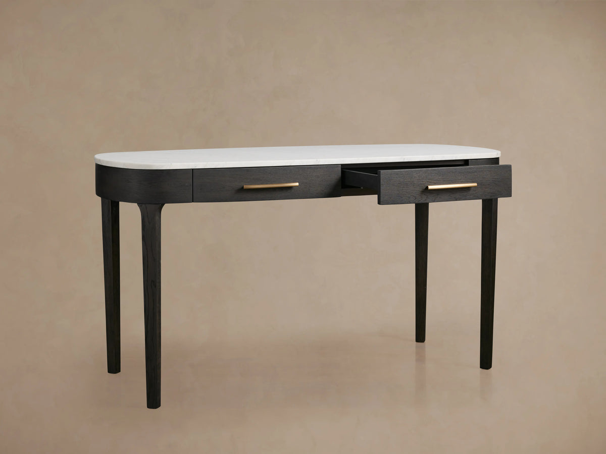 Danny Writing Desk, ebony finish with white marble top. One of two drawers with brass pull is open, front view.