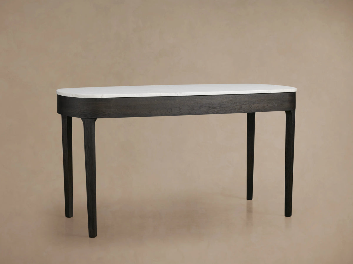 Danny Writing Desk, top-down view. Elongated white Carrara marble top with natural veining and rounded corners on a beige background.
