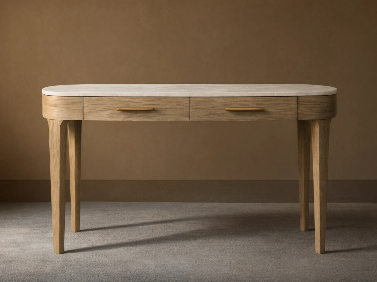 Danny Writing Desk with an oval white marble top, two fawn wood drawers with brass pulls, and four tapered legs.