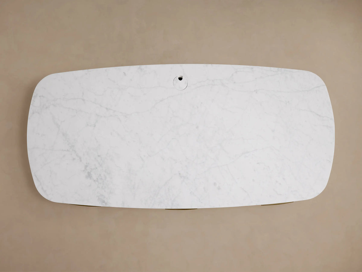 Danny Executive Desk with white Carrara marble top, light fawn oak veneer base, and a curved, modern design, facing forward.