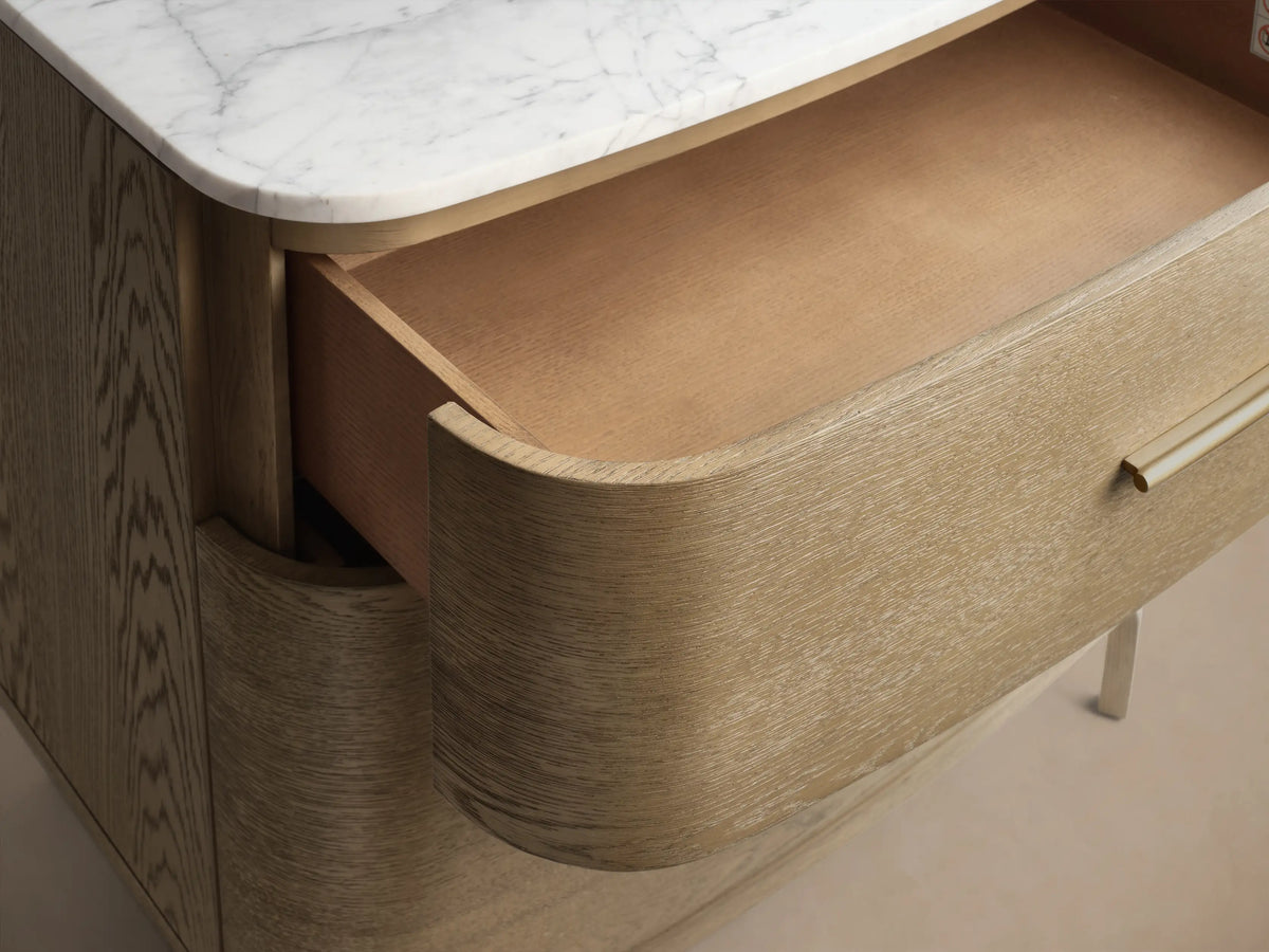 Front view of the Danny File Cabinet, featuring a white Carrara marble top and two light brown oak veneer drawers with brass handles.