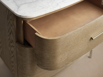 Front view of the Danny File Cabinet, featuring a white Carrara marble top and two light brown oak veneer drawers with brass handles.