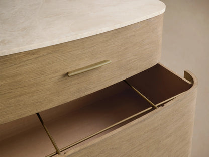 Close-up of Danny File Cabinet with white Carrara marble top and a partially open light oak veneer drawer with brass hardware.