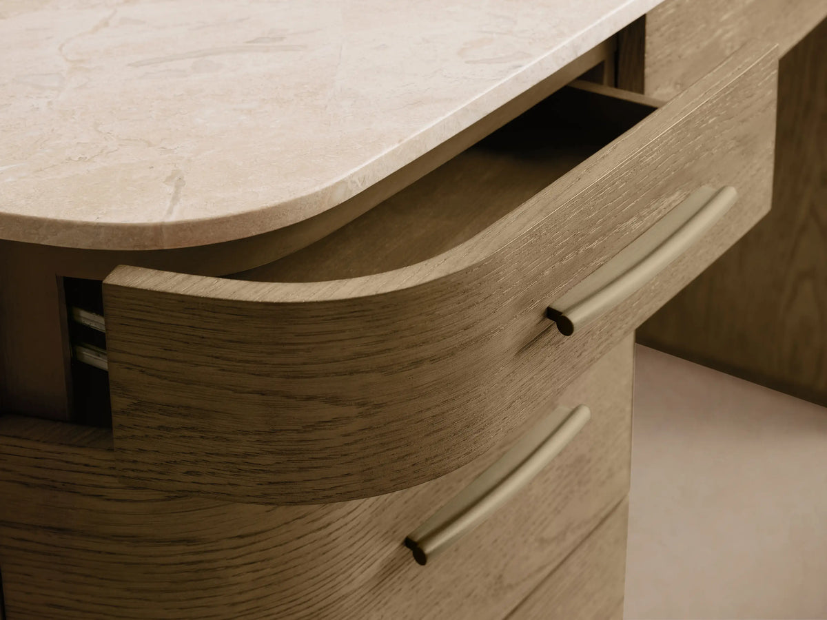 Danny Executive Desk: Fawn oak veneer desk with curved front drawers, white marble top, and brass hardware, on a beige background.