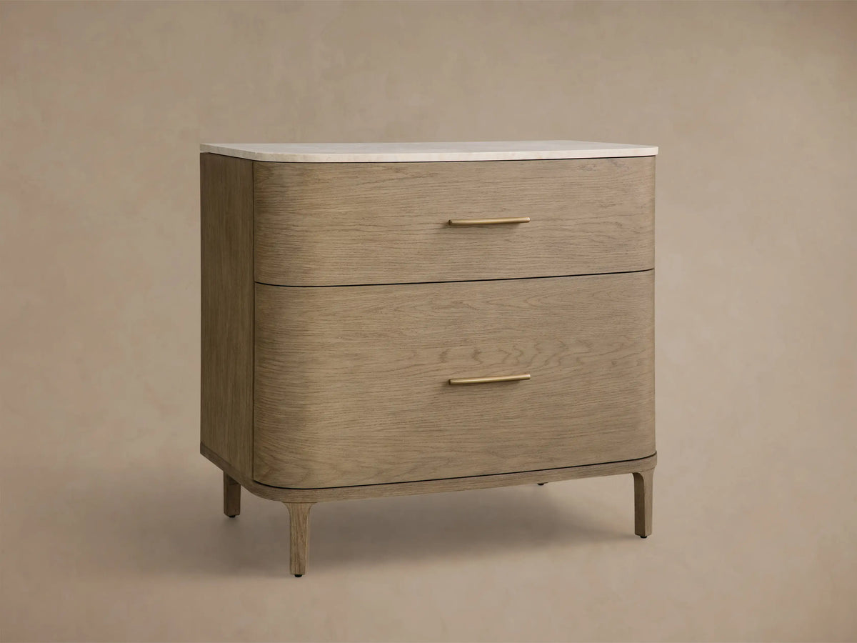 Front view of the Danny File Cabinet, featuring light oak veneer, two curved drawers with brass pulls, and a white marble top.