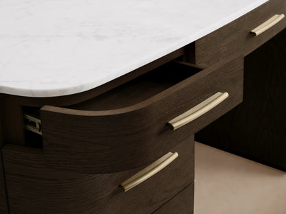 Front view of the Danny Executive Desk, featuring dark oak veneer with a white marble top and seven drawers with brass pulls.