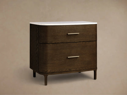 Front view of the dark brown Danny File Cabinet™ with two drawers, brass handles, rounded edges, and a white marble top.