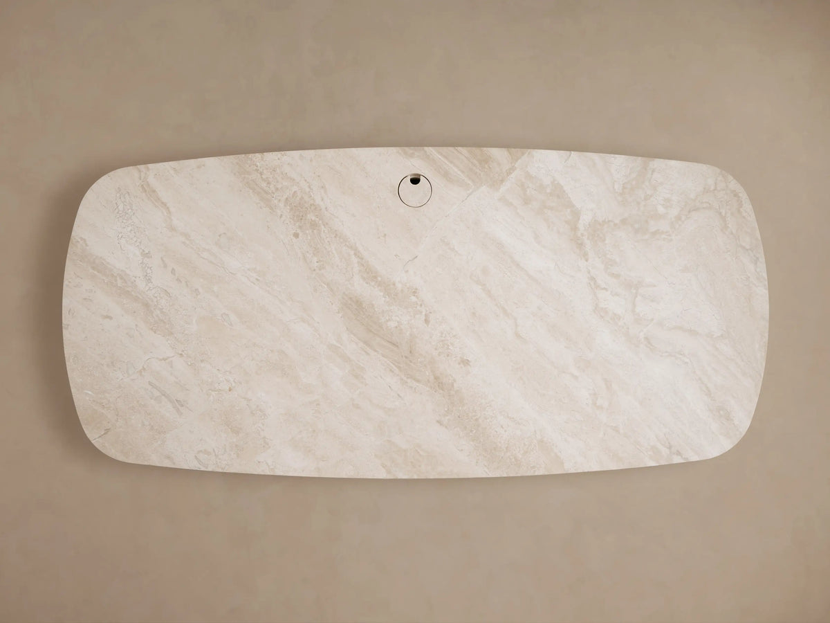 Top-down view of the earth-toned royal cream marble Danny Executive Desk, featuring natural veining and a central cord management grommet.