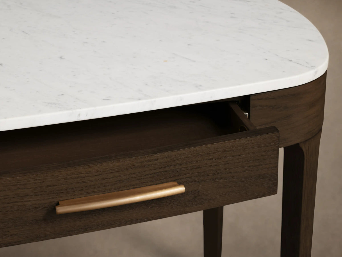 Front view of the Danny Writing Desk with a white Carrara marble top, dark brown oak veneer body, and two drawers with brass handles.