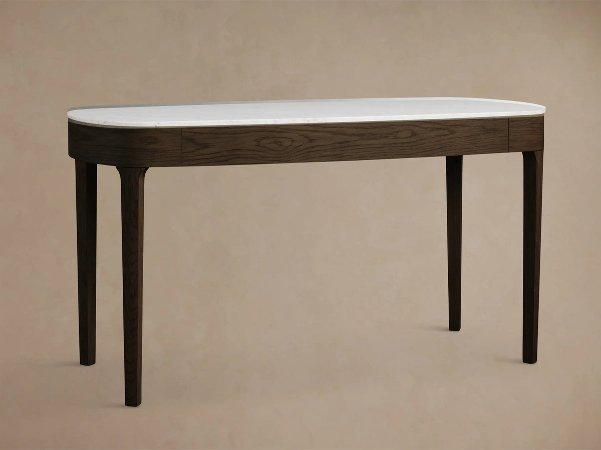 Top-down view of the white Carrara marble top of the Danny Writing Desk, showing natural gray veining and rounded corners.