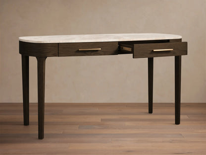 Front view of the Danny Writing Desk with a white marble top, dark oak veneer, and brass hardware; one drawer is partially open.