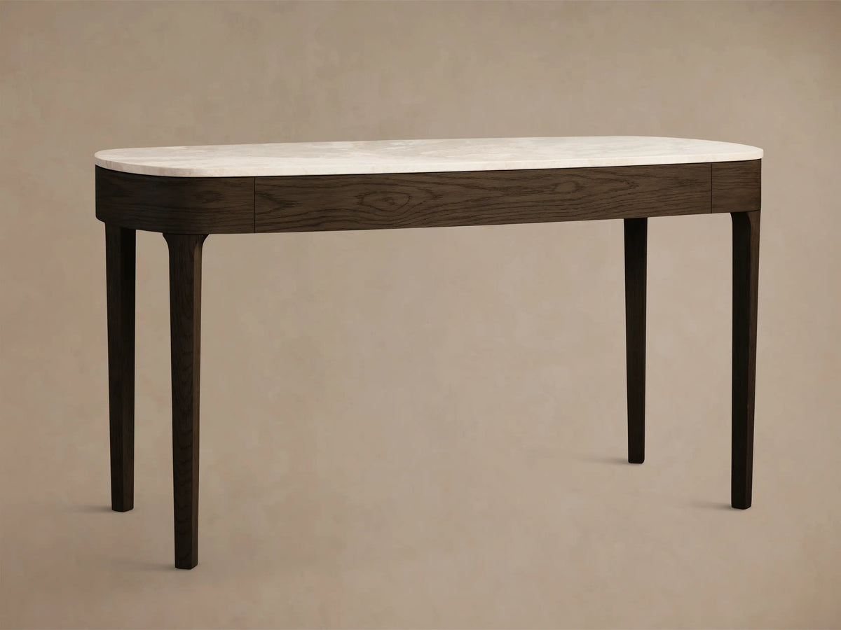 Close-up of the Danny Writing Desk, featuring its royal cream marble top and an open dark oak drawer with a brass pull.