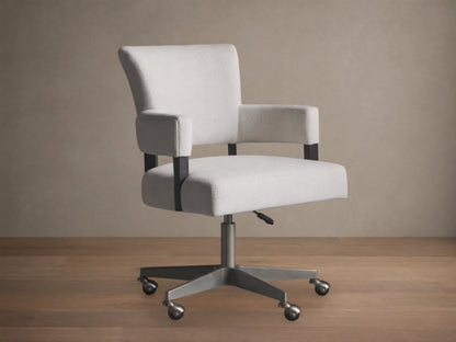 Light grey Fallyn Desk Chair with padded armrests and backrest on a metal swivel base with five wheels, set on a wooden floor.